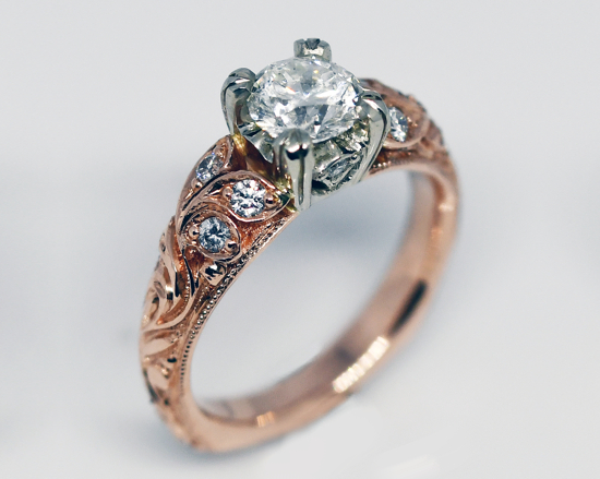 Ideal cut diamond. Delicate hand engraving with organic motifs flows with blue sapphires, emeralds, and diamonds engagement ring